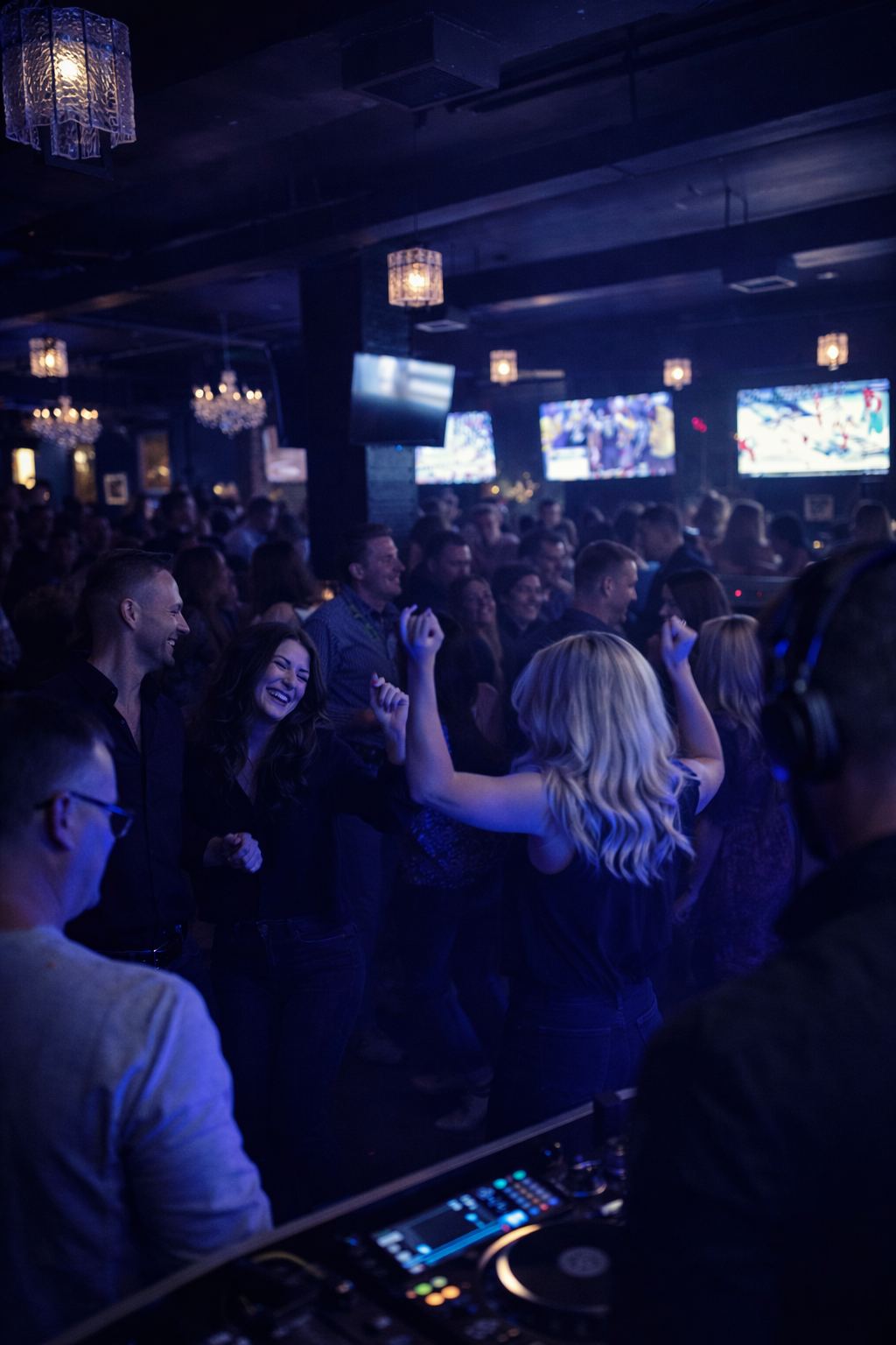 A packed Saturday night crowd dancing behind the DJ booth at Suite 200 in Milton, Georgia
